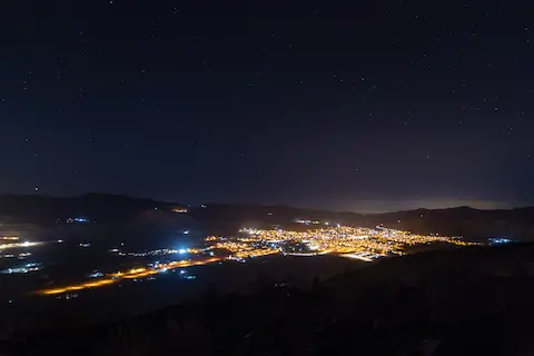 Andacollo at night, with the glow of La Serena visible to the right.